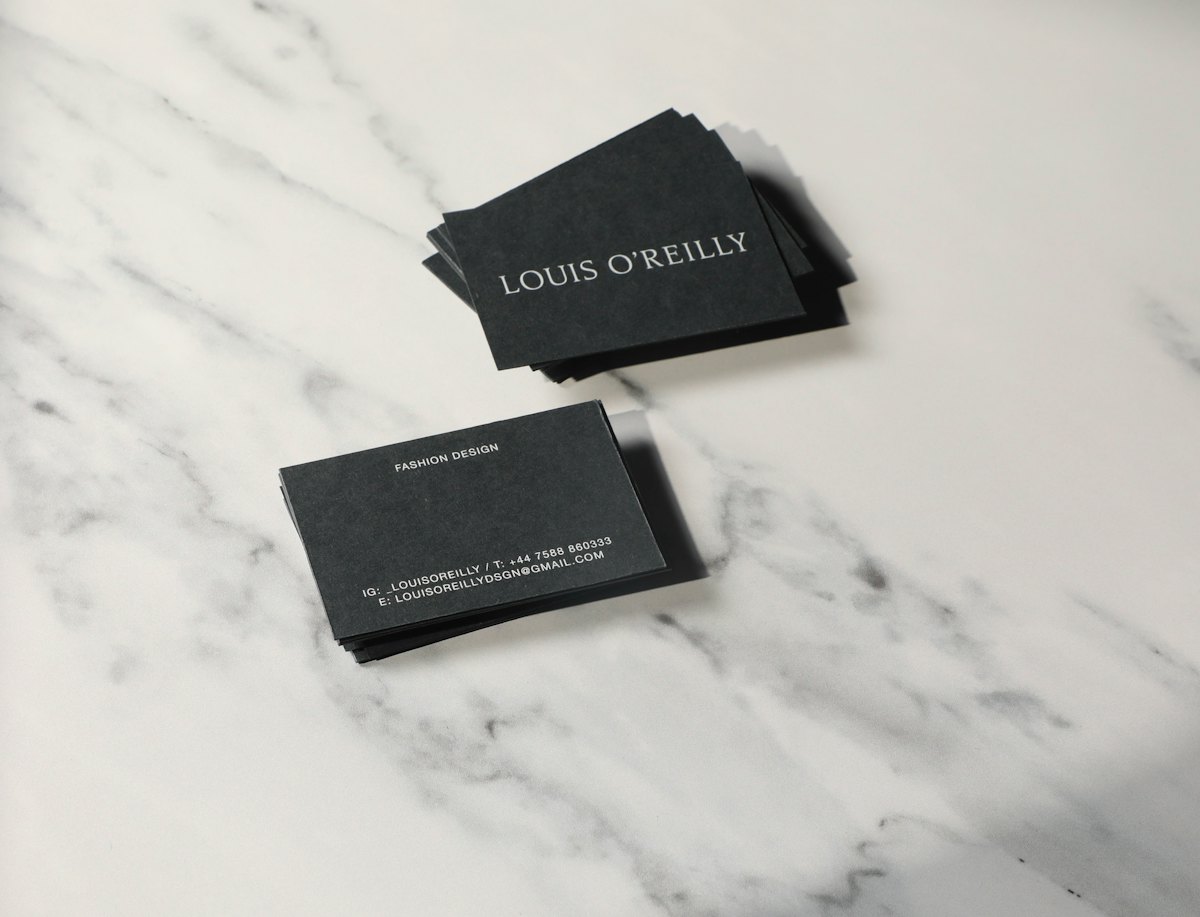 Printed business cards scattered across a desk