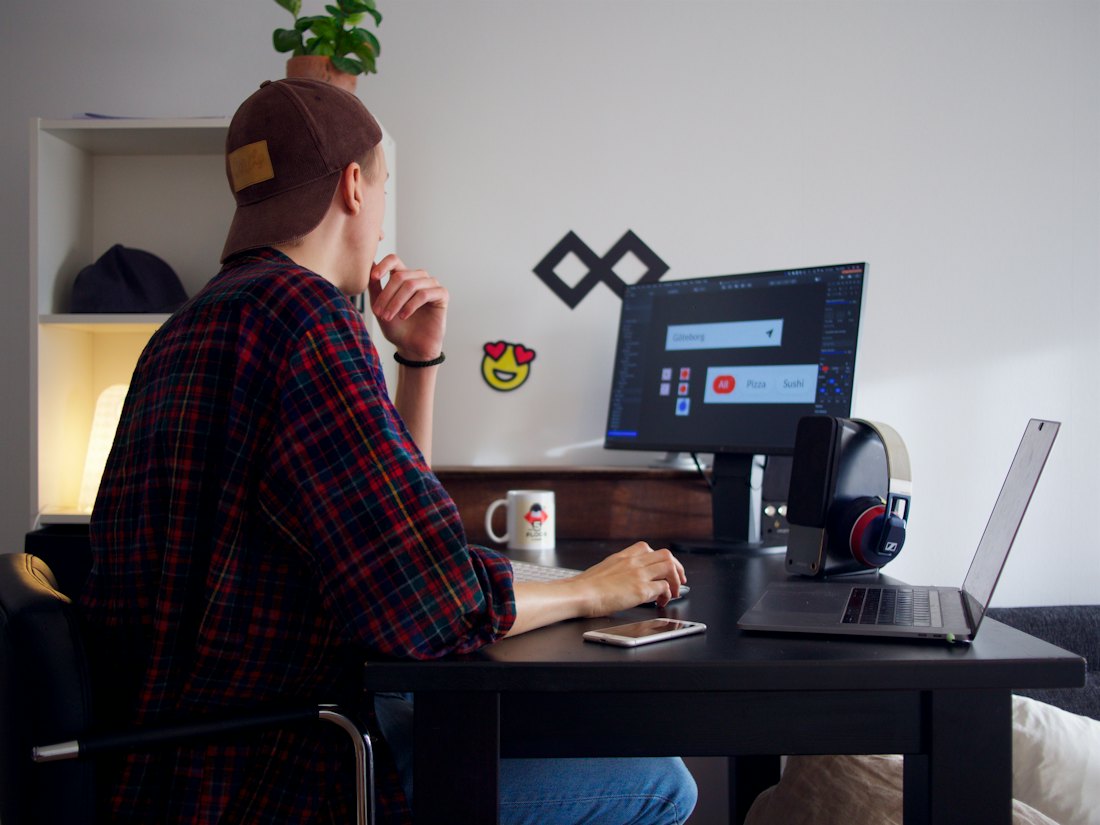 A person working at a laptop at a desk.
