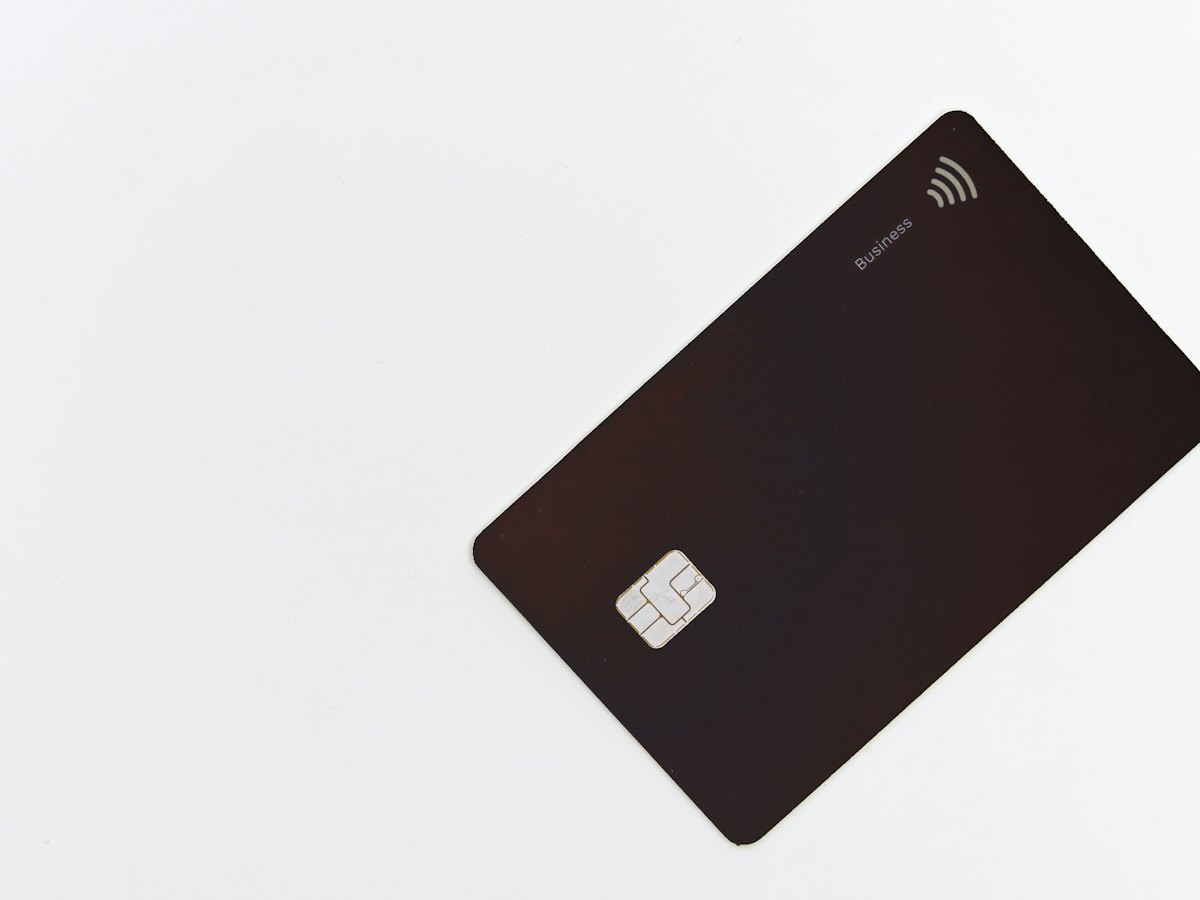 A dark NFC smart card photographed on a pale surface