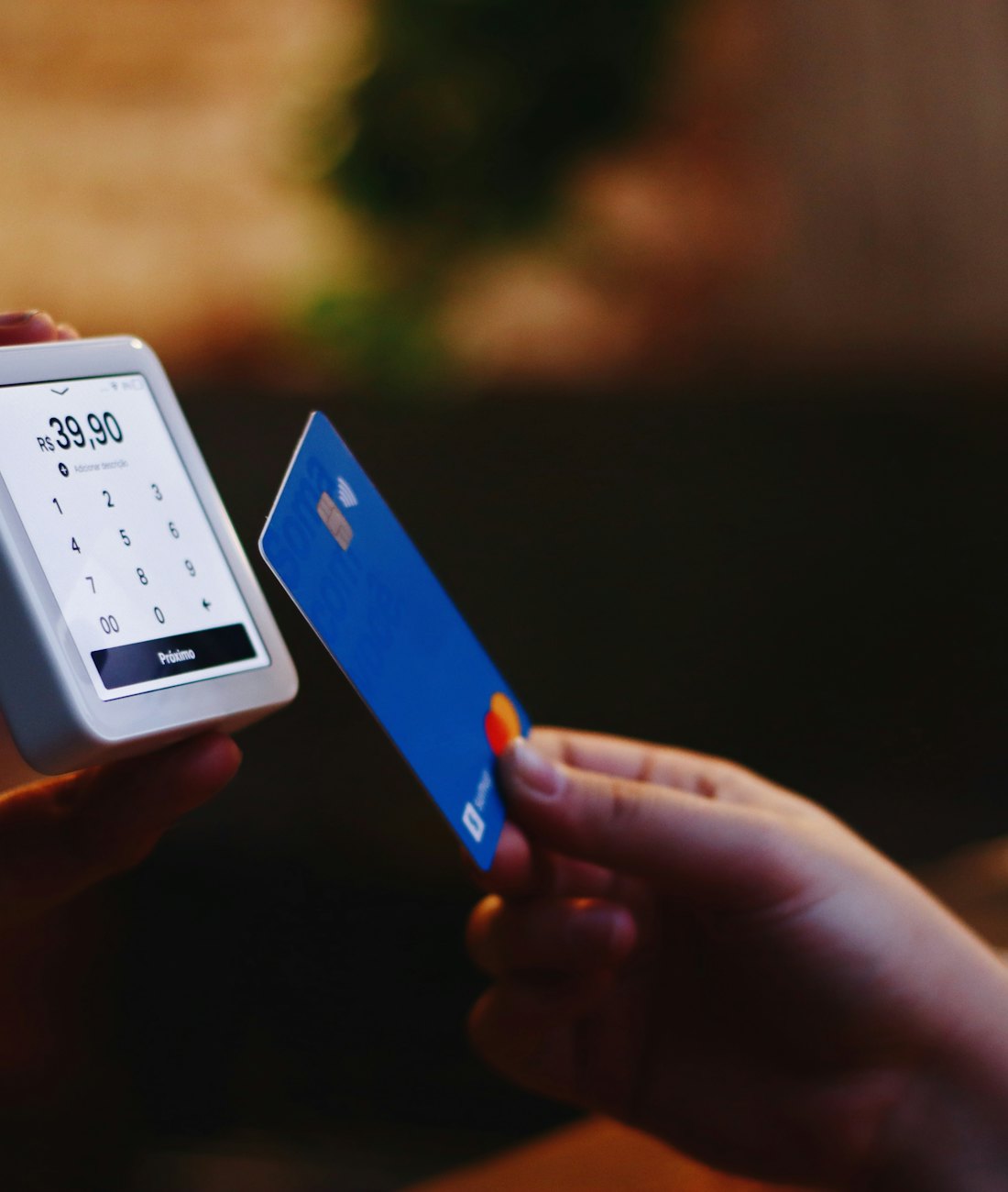 A person holding a smart card beside a phone to share a digital profile